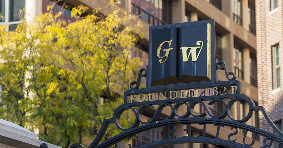 GW symbol on a campus gate overlooking campus